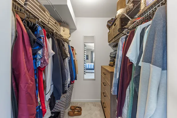 a view of walk in closet with clothes
