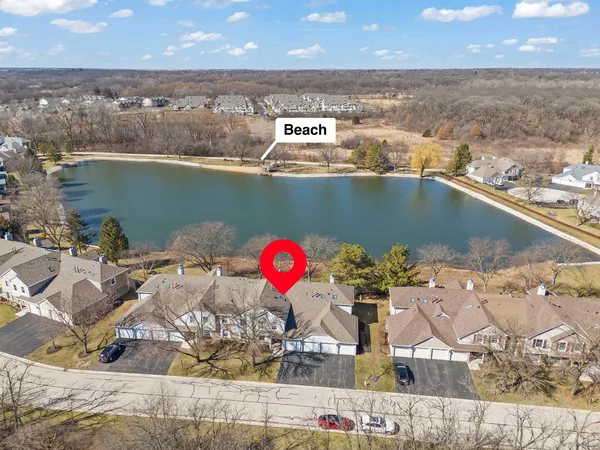 an aerial view of a house with a lake view