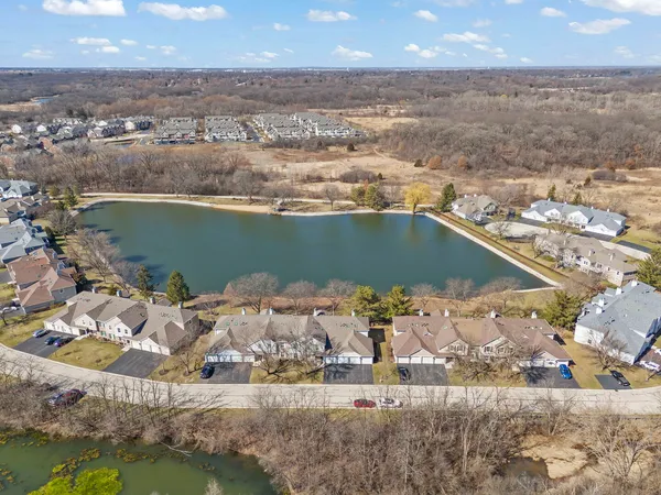 an aerial view of a house with a lake view