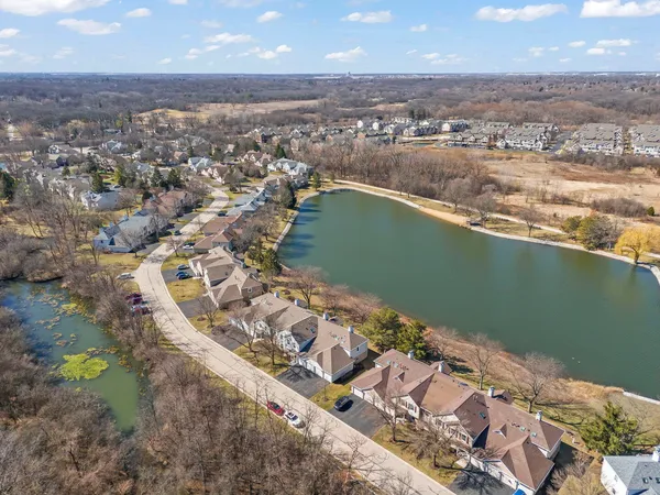 an aerial view of a houses with a lake