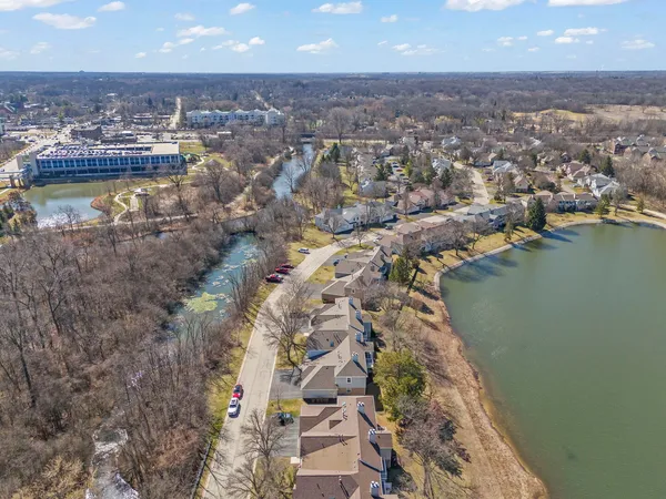 an aerial view of a house with a lake view