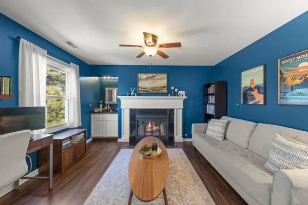 a living room with furniture fireplace and window
