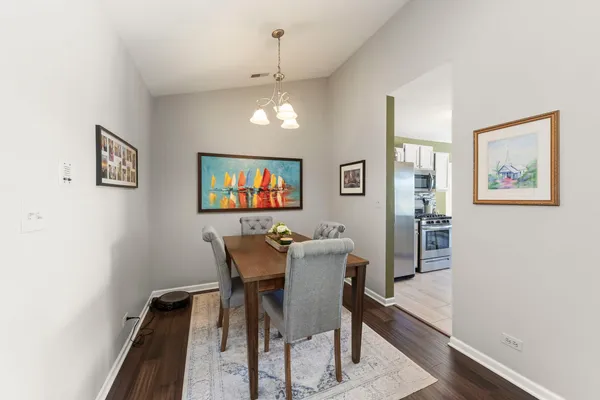 a view of a dining room with furniture and wooden floor