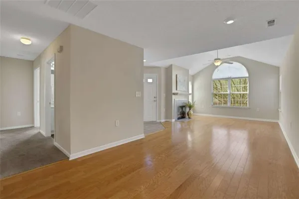 a kitchen with a sink cabinets and wooden floor