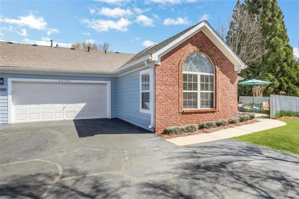 a view of a house with backyard and trees