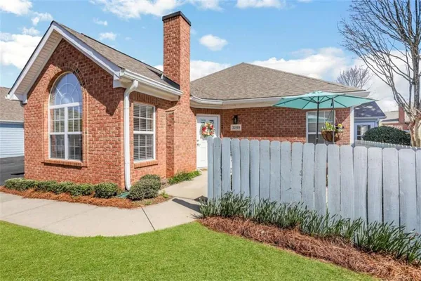a front view of a house with a yard and outdoor seating