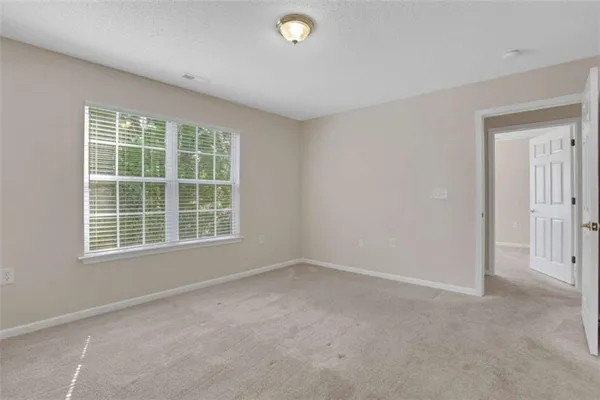 a bathroom with a granite countertop toilet sink and mirror