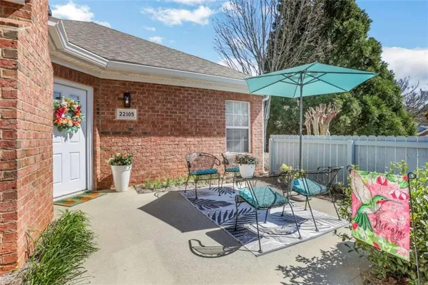 a view of backyard with outdoor seating and plants