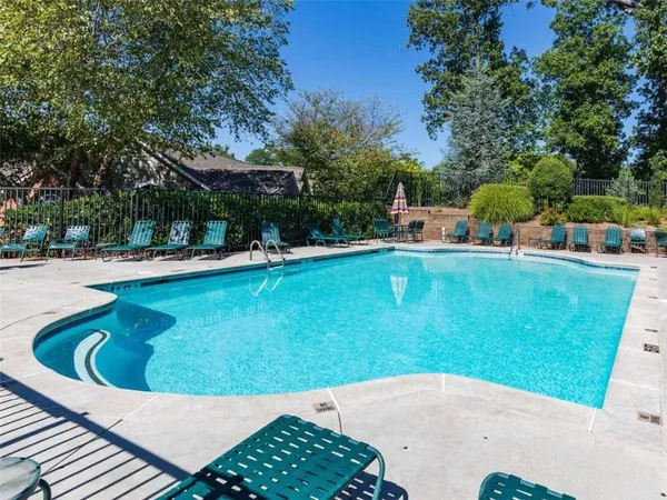 a kitchen with kitchen island white cabinets and refrigerator