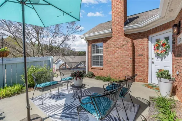 a view of backyard with outdoor seating and plants