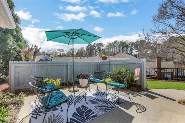 a view of a table and chairs under an umbrella in patio