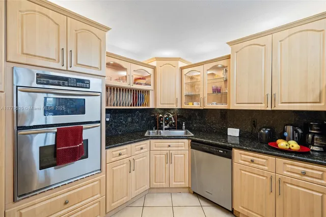 a kitchen with stainless steel appliances granite countertop a stove and cabinets