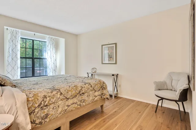 a bedroom with a bed and a chair