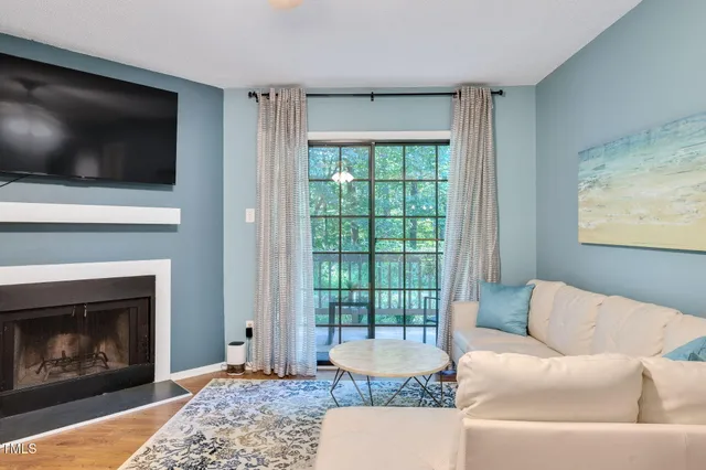 a living room with a flat screen tv and a fireplace