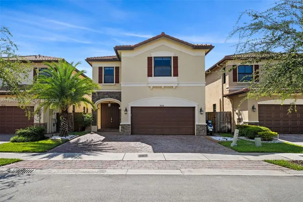 a front view of a house with a yard and garage
