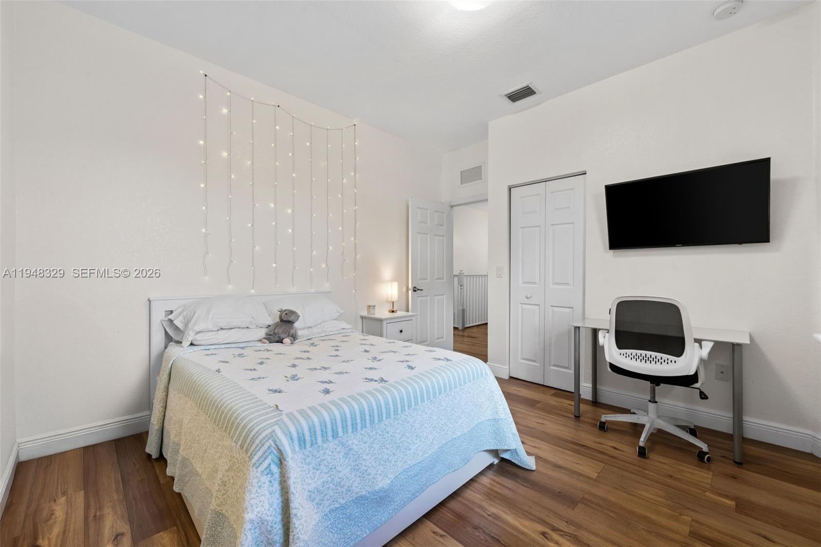 8658 Northwest 99th Path Doral, FL 33178 - Photo 11 of 46 a bedroom with a bed and a a flat screen tv