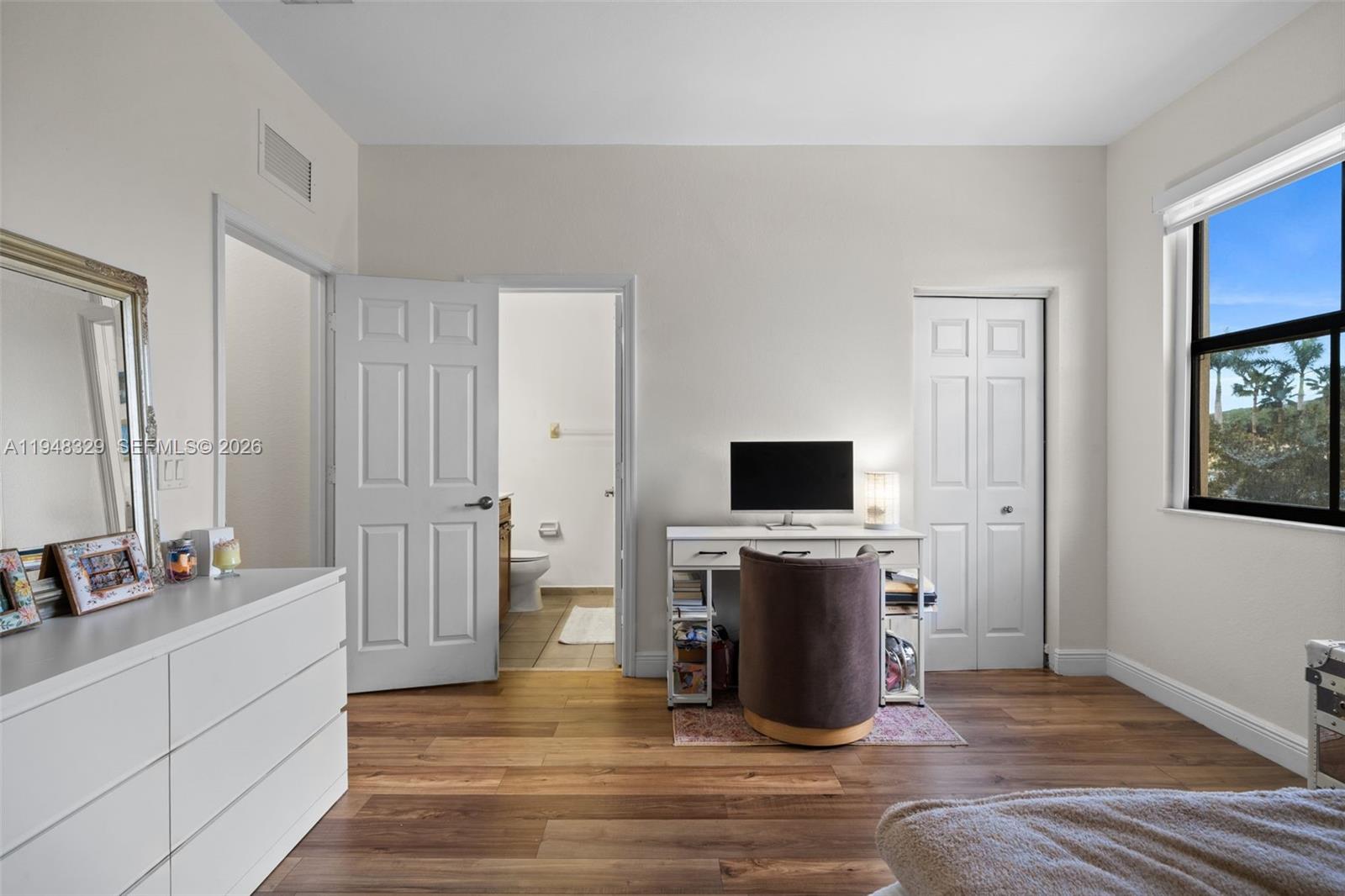 8658 Northwest 99th Path Doral, FL 33178 - Photo 13 of 46 a view of a livingroom with wooden floor and a fireplace
