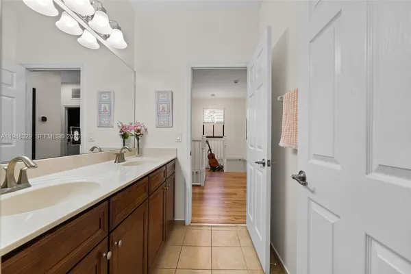 a bathroom with a sink a mirror and a shower
