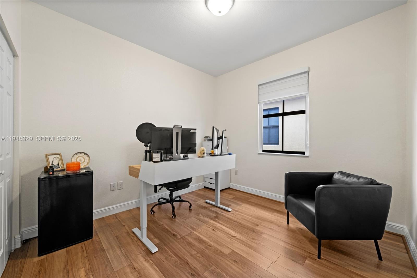 8658 Northwest 99th Path Doral, FL 33178 - Photo 19 of 46 a view of a workspace with furniture and wooden floor