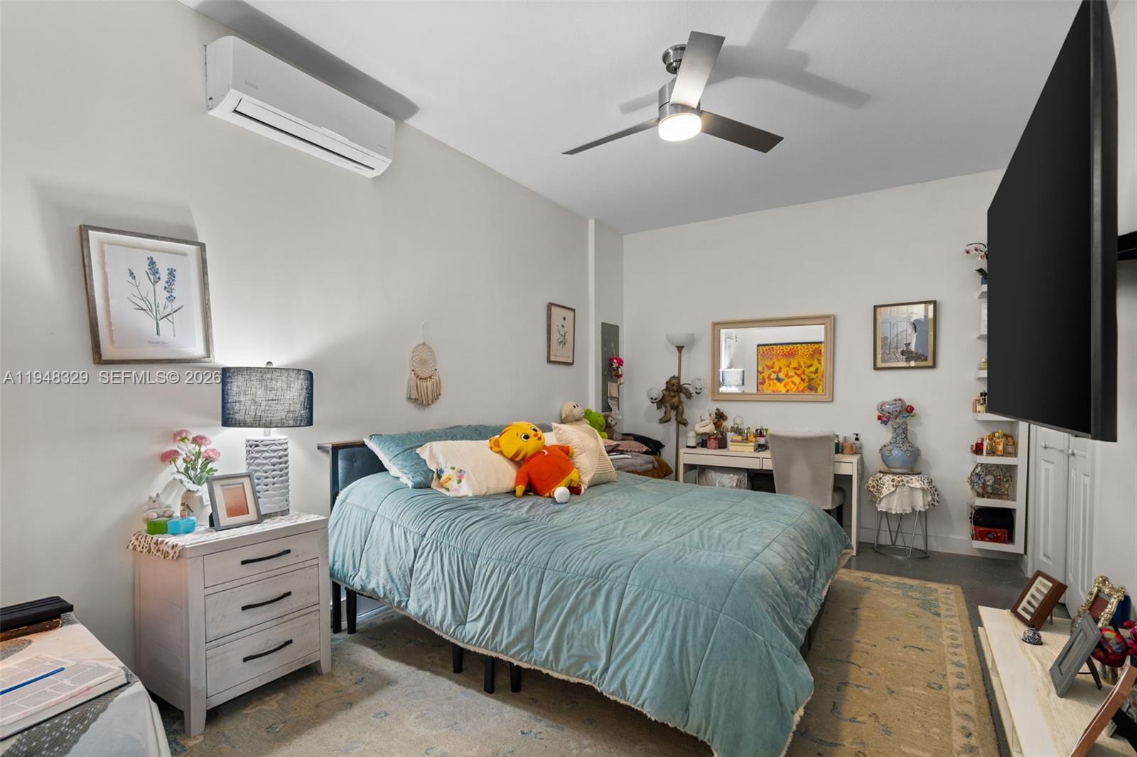 8658 Northwest 99th Path Doral, FL 33178 - Photo 27 of 46 a bedroom with a bed and a tv