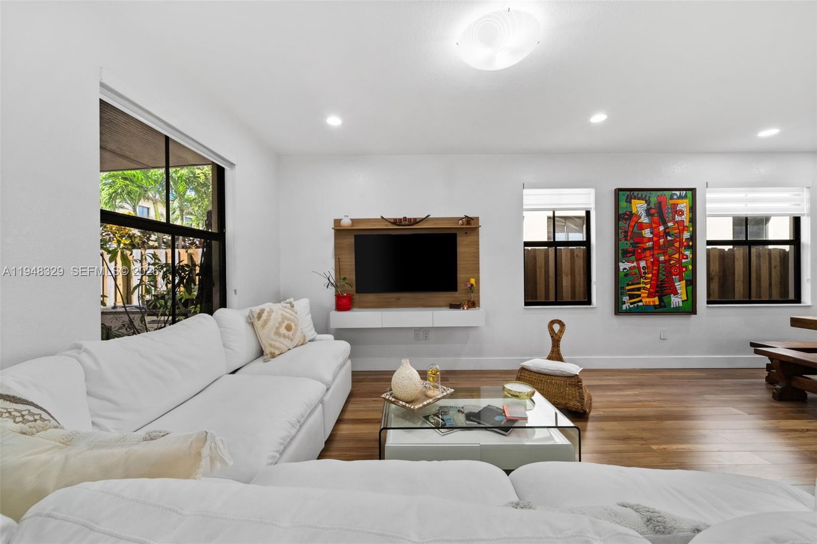 8658 Northwest 99th Path Doral, FL 33178 - Photo 36 of 46 a living room with furniture and a flat screen tv