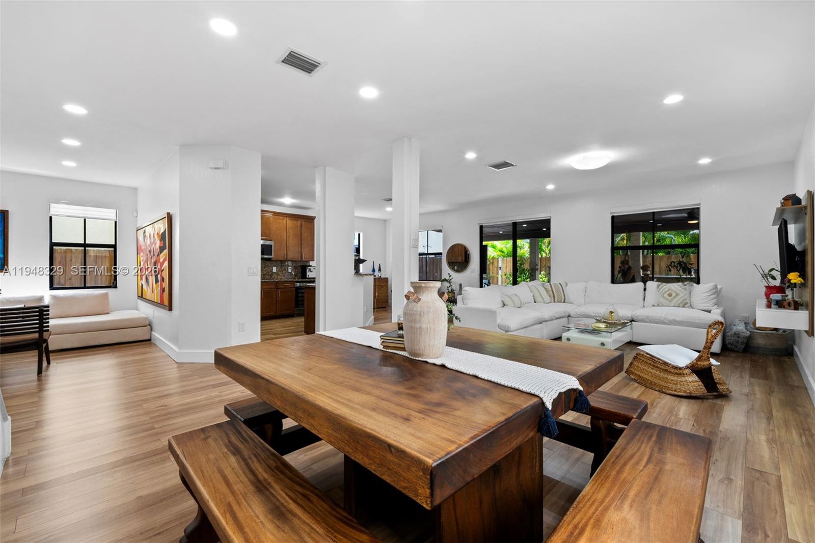 8658 Northwest 99th Path Doral, FL 33178 - Photo 38 of 46 a living room with furniture a wooden floor and a table