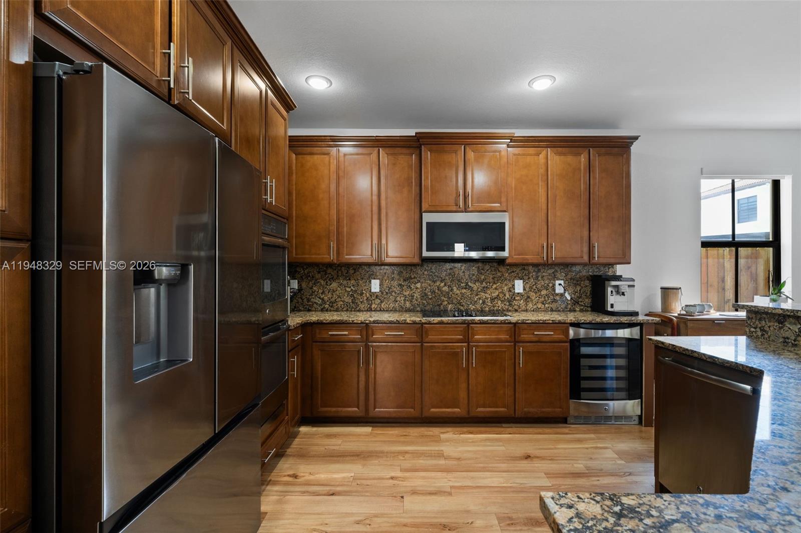 8658 Northwest 99th Path Doral, FL 33178 - Photo 40 of 46 a kitchen with stainless steel appliances granite countertop a refrigerator a stove a sink and a microwave