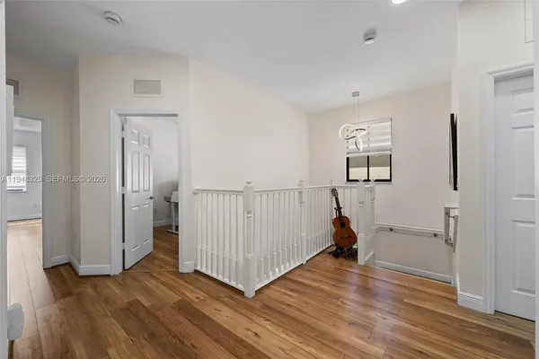 a view of a room with wooden floor and windows