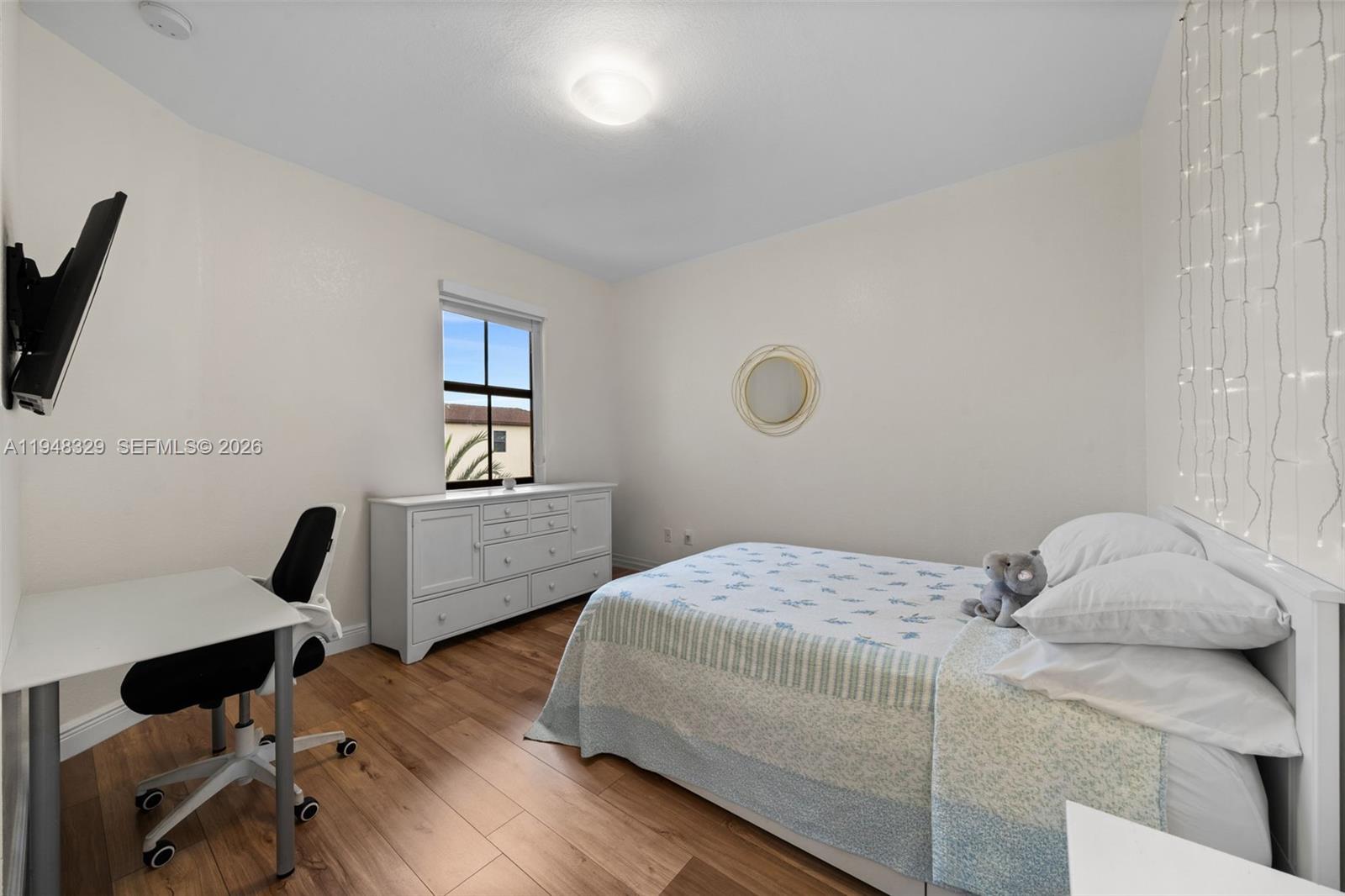 8658 Northwest 99th Path Doral, FL 33178 - Photo 9 of 46 a bedroom with a bed and a computer on the desk