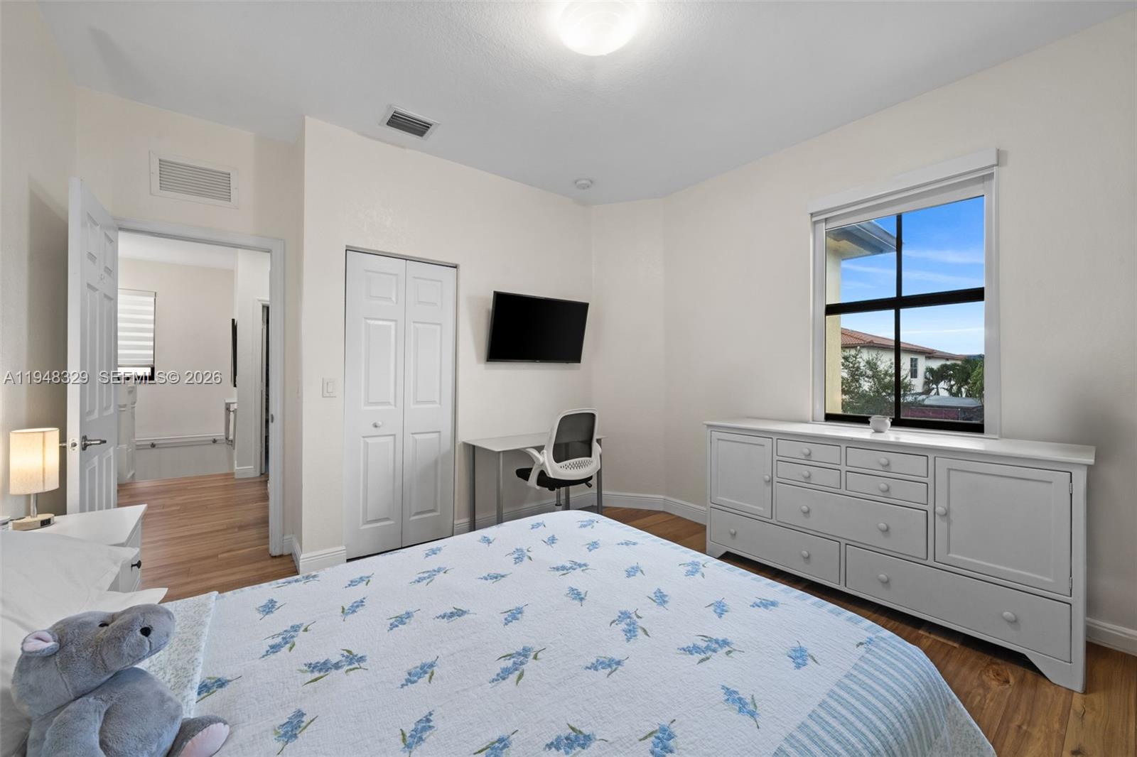 8658 Northwest 99th Path Doral, FL 33178 - Photo 10 of 46 a bedroom with a bed and a window