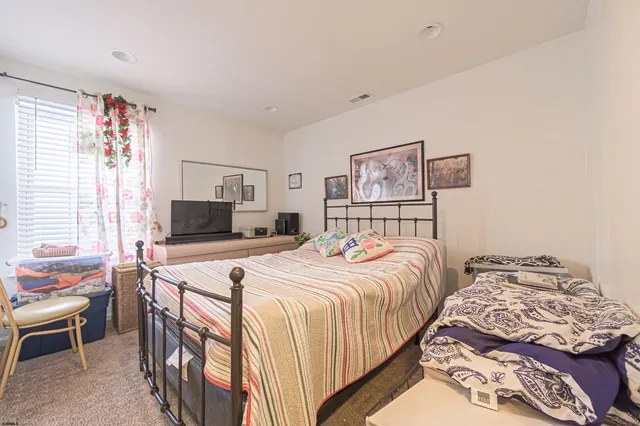 a bedroom with double bed and a window