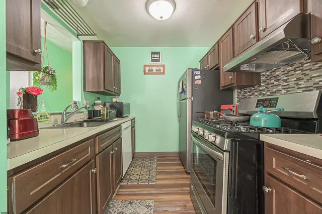 a kitchen with stainless steel appliances granite countertop a stove and a sink