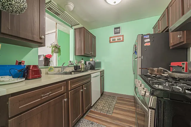 a kitchen with stainless steel appliances granite countertop a sink stove and refrigerator