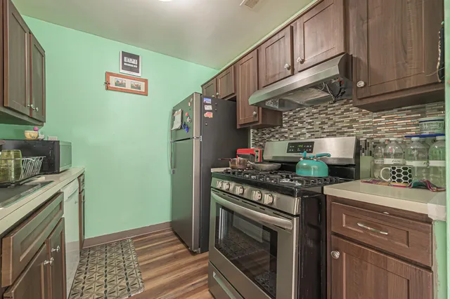 a kitchen with stainless steel appliances granite countertop a stove and a cabinets
