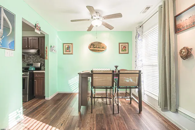 a view of a dining room with furniture and wooden floor