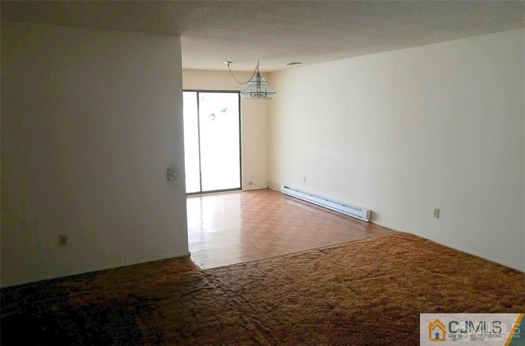 40 C Haddon Road Monroe Township, NJ 08831 - Photo 2 of 12 an empty room with an empty space and a window