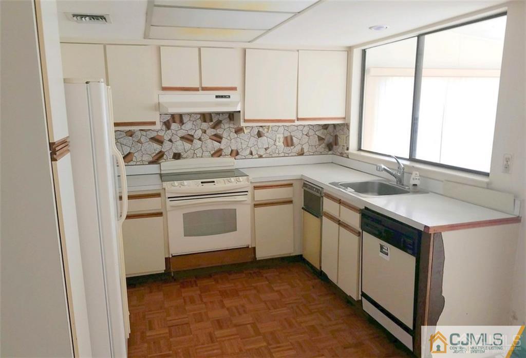 40 C Haddon Road Monroe Township, NJ 08831 - Photo 6 of 12 a kitchen with white cabinets and white appliances