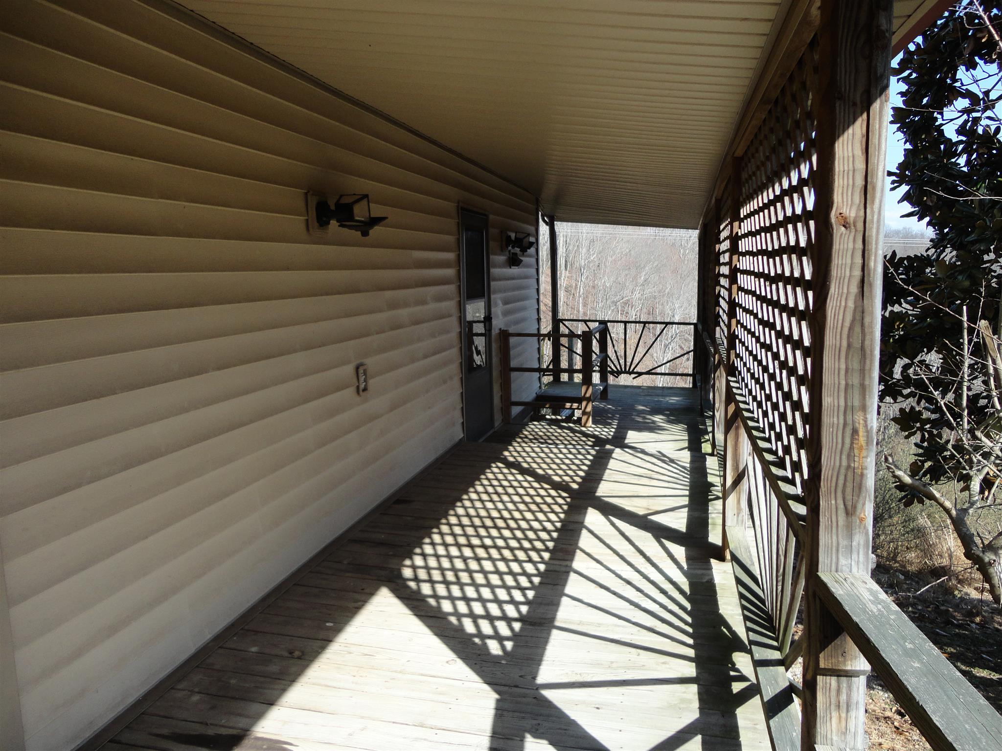 2478 Hurricane Ridge Road Smithville, TN 37166 - Photo 4 of 15 wraparound porch with side entrance to kitchen