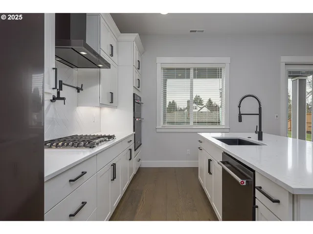 a kitchen with a sink stove and refrigerator