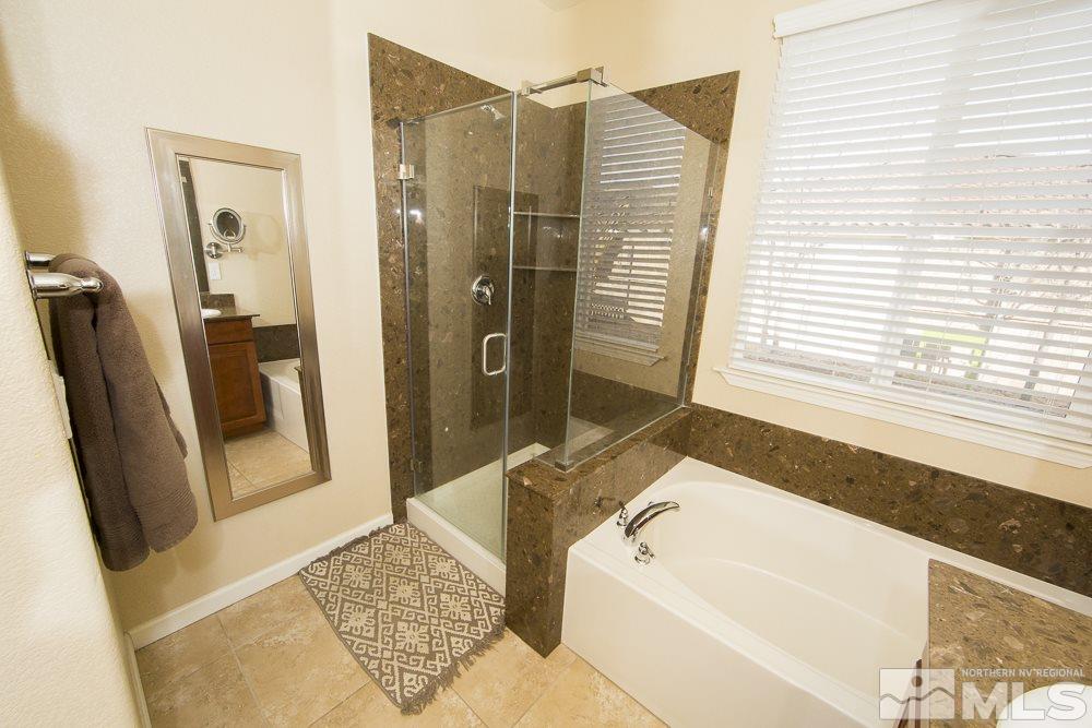 10898 Oakhaven Drive Reno, NV 89521 - Photo 12 of 19 a bathroom with a tub sink and a shower