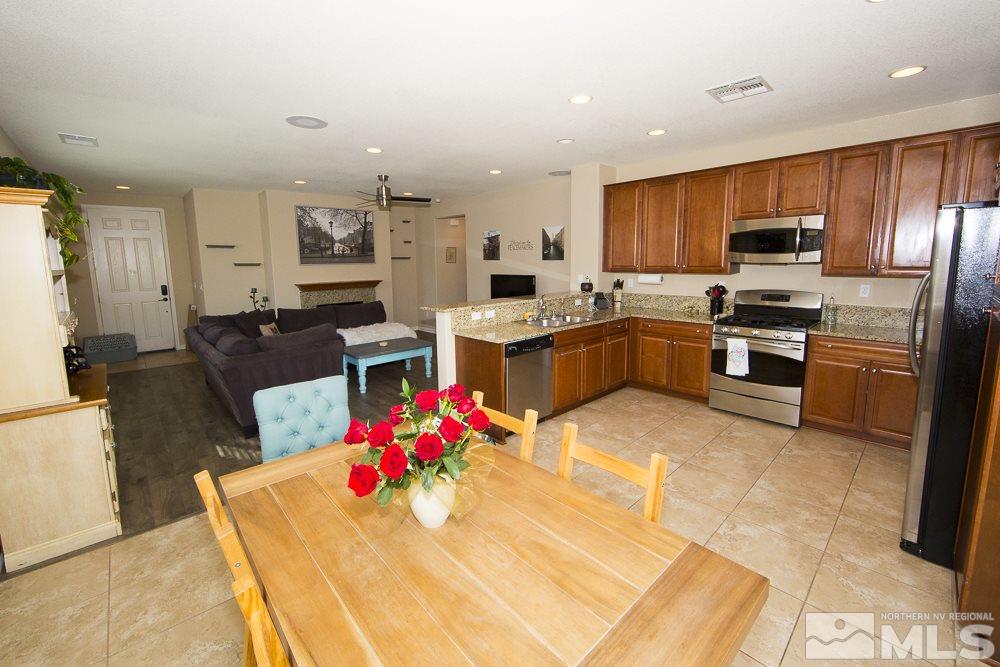10898 Oakhaven Drive Reno, NV 89521 - Photo 4 of 19 a kitchen with cabinets and stainless steel appliances