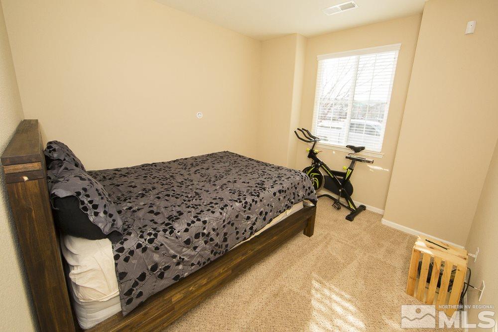 10898 Oakhaven Drive Reno, NV 89521 - Photo 8 of 19 a bed sitting in a bedroom next to a window