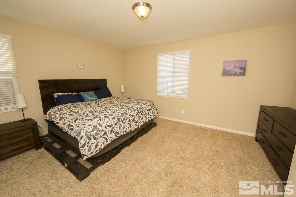 10898 Oakhaven Drive Reno, NV 89521 - Photo 9 of 19 a bedroom with a bed and a potted plant next to a window