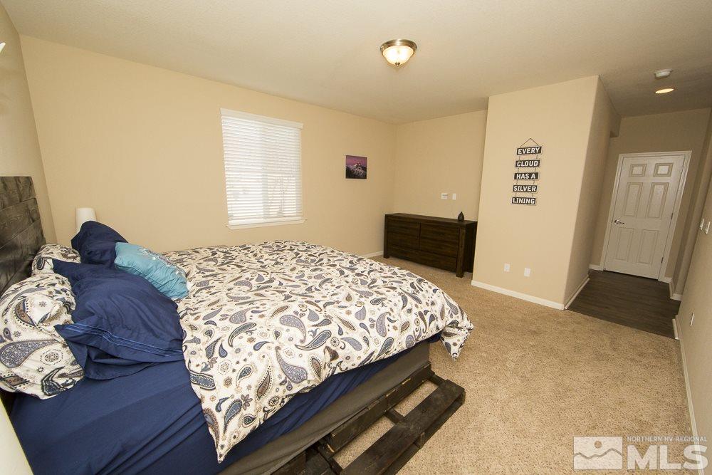 10898 Oakhaven Drive Reno, NV 89521 - Photo 10 of 19 a bedroom with a bed and wooden floor