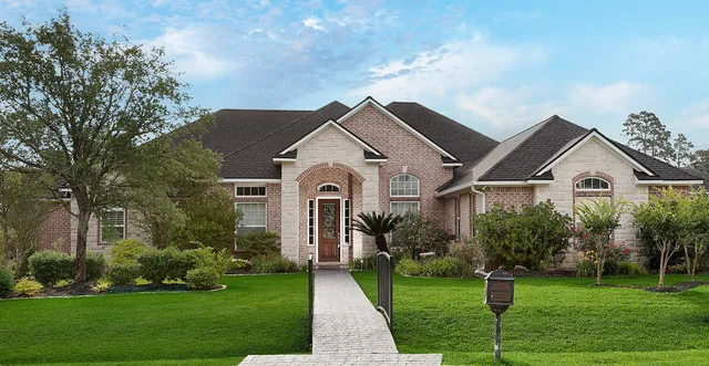 a front view of house with yard and green space