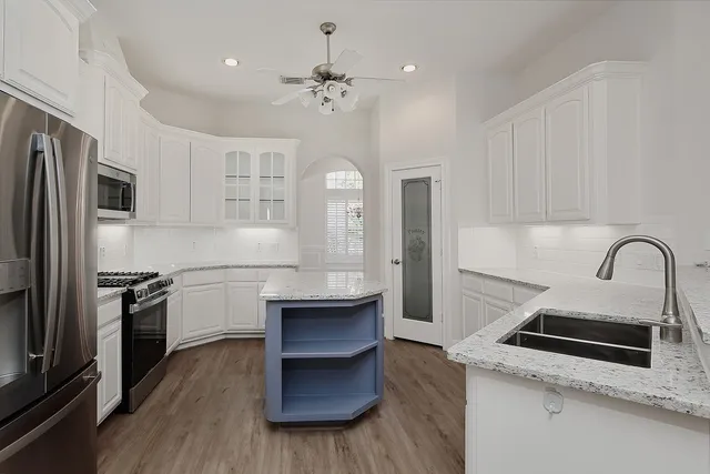 a kitchen with a refrigerator stove and sink