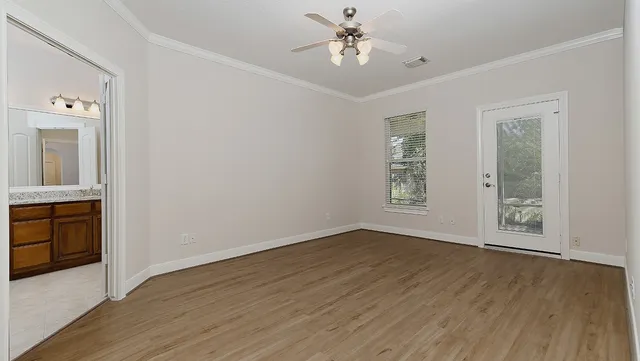 wooden floor in an empty room with a window