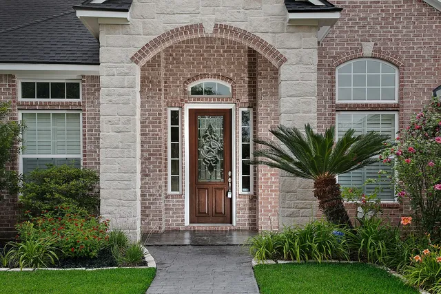 a front view of a house with a garden
