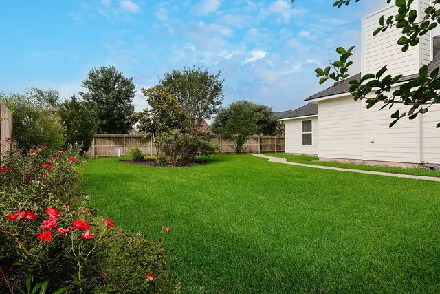 a view of a house with a yard and garden