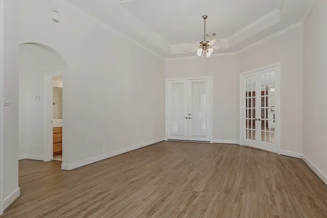 wooden floor in an empty room with a window